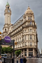 A Subte entrance near an imposing historic building and a striking clock tower, Historic buildings