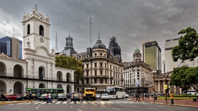 Different architectural styles meet under a cloudy sky in an urban space, Historic buildings in the