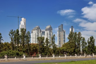 A skyline with modern skyscrapers, trees and a street against a blue sky, The city of Buenos Aires
