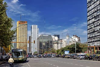 A busy street in a city with many skyscrapers and heavy traffic under a clear sky, The city of