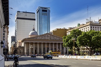 A grand cathedral and modern buildings along a busy tree-lined street, The city of Buenos Aires in