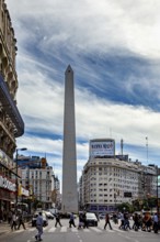 A lively urban square with a tall obelisk in the centre and surrounding buildings, The Great