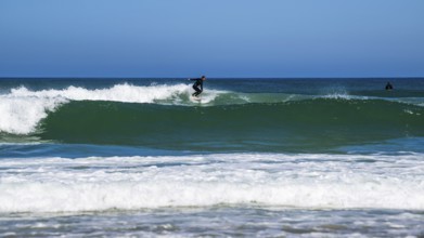 Surfer riding a wave on Contis beach, Saint Julien en Born, Saint-Julien-en-Born, Landes, France