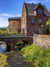 The old town centre with the town wall and the Seemenbach stream, Büdingen, Hesse, Germany