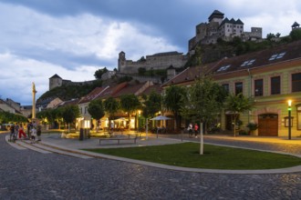 Night shot of the Peace Square in the historic centre of Trencín, Trencín Castle in the background,