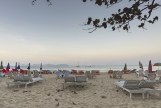Abandoned deckchairs and parasol after sunset at Charlie Beach, Koh Mook Island, Andaman Sea,