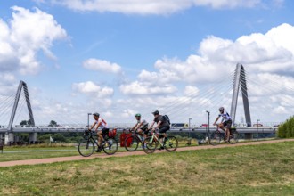 Cycle path in the Neulandpark in Leverkusen on the Rhine, in the background the new Rhine bridge of