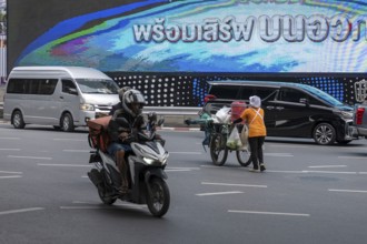 Street crossing woman with cookshop, Bangkok, Thailand