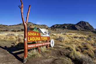 Signpost in the nature park pointing to a hiking trail under a clear blue sky, The Perito Moreno