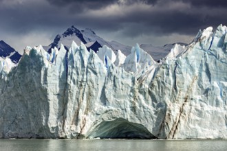 Dramatic glacier with threatening clouds and mountains in the background, The Perito Moreno glacier