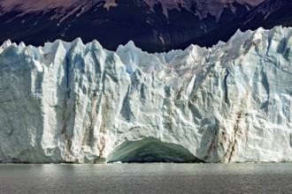 Impressive ice wall of a glacier with clear lines and a blue sky, The glacier of Perito Moreno in