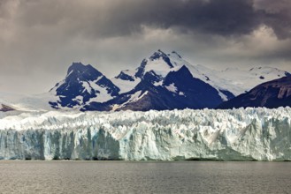 A powerful view of snow-covered mountains and glaciers under a gloomy sky, The Perito Moreno