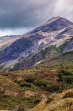 Imposing mountain with steep slopes and dense vegetation under a cloudy sky, the Patagonian