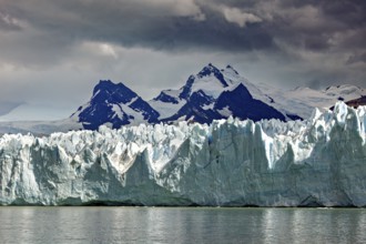 Imposing glacier merges with snow-covered mountains and sky, The Perito Moreno glacier in Argentina