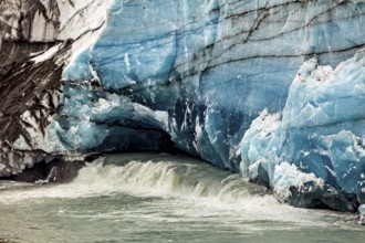 Close-up of a blue-white glacier wall with flowing water, The glacier of Perito Moreno in Argentina