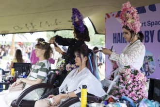 Festival visitors get their hair styled at Fashionpalooza at the Lollapalooza Festival in the