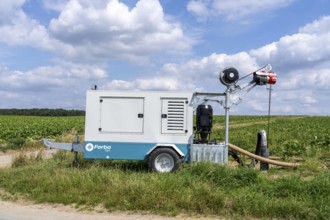Mobile pump for artificial irrigation with a sprinkler system in a field where sugar beet is grown,