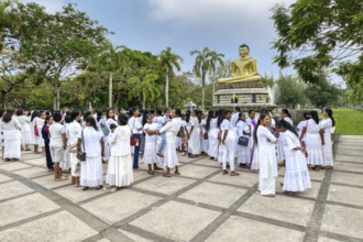 Pilgrims in front of a Buddha statue, Colombo, Sri Lanka