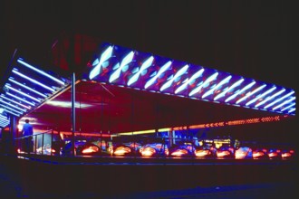 Illuminated bumper cars at night, New Jersey, USA