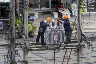 Electricians working on power lines, Pattaya, Thailand