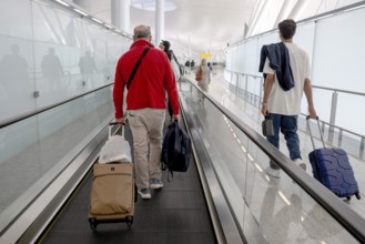 Airport moving walkway Passengers with hand luggage, Abu Dhabi, United Arab Emirates
