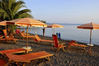 Beach, deckchairs, sunshades at the lido, Lake Bolsena, Lago di Bolsena, volcanic crater lake, calm