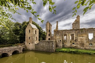 Medieval ruins under a dramatic sky with nature in the foreground, Gratot Castle in Normandy,