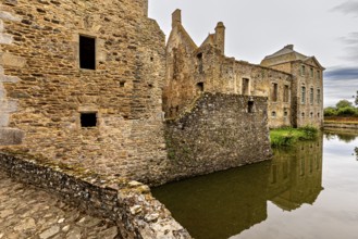 Historic castle with moat and reflection in a tranquil atmosphere, Gratot Castle in Normandy,