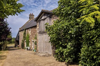 A traditional stone house surrounded by lush greenery on a summer's day, Historic houses in
