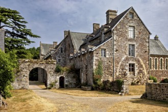 A historic stone building with archway and vegetation under a cloudy sky, The Abbey de La Lucerne