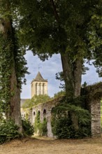 A tower surrounded by tall trees and an overgrown stone wall in a tranquil setting, The Abbey of La