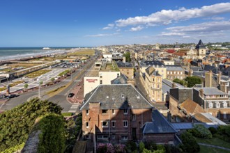 City panorama on the coast with promenade and historic buildings under a blue sky, The city of