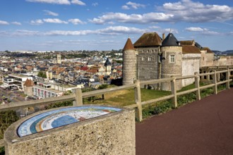Castle with city view in the background, under a blue sky with white clouds, wide view of the city