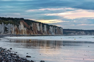 Rocky cliffs by the sea at sunset with a calm atmosphere and a cloudy sky, The cliffs near Dieppe