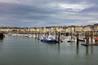 A busy harbour full of boats against a backdrop of charming old buildings, The harbour of Dieppe in