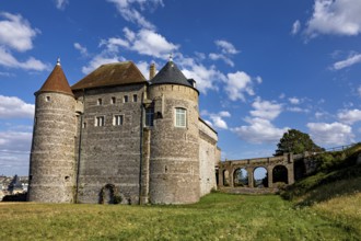 Medieval castle with round towers and stone walls under a blue sky on a green meadow, Dieppe Castle