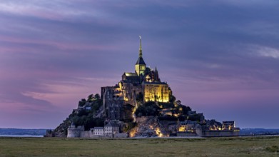 Mont Saint-Michel at sunset with lighting and coloured sky, Mont Saint Michel in Normandy, France