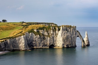 Dramatic cliffs with striking rock formations, surrounded by calm seas and cloudy skies, The cliffs