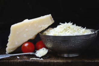 Parmesan cheese, grated cheese in rind and piece of Parmesan, Italy