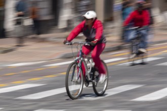 Woman riding a bicycle, Photo with motion blur, City of Quito, Pichincha province, Ecuador, South