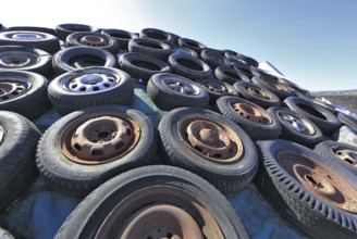 Old wheels, rims and tyres, used here to weigh down the cover of an agricultural silo
