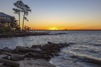 Sunset over the railroad bridge across Bay of Saint Louis from Henderson Point in Pass Christian,