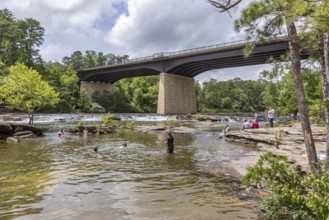 People playing on the rocks under the Little River Falls Bridge in Little River Canyon Falls Park