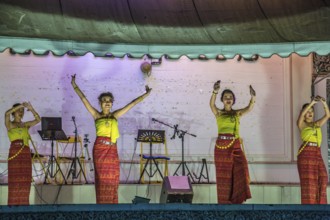 Traditional Thai dancers perform on a lighted stage at the night market in downtown Chiang Rai,