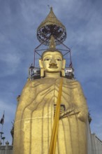 32 metre high standing Buddha decorated with glass mosaics and 24 carat gold, the upper knot of the