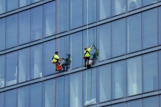 Detroit, Michigan - Window washers at the 25-story Residences Water Square luxury apartment