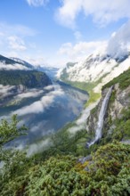 Gjerdefossen waterfall, at Ørnesvingen viewpoint, atmospheric clouds over the fjord in the morning