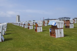 Beach chairs on the green beach, high-rise building, Büsum, North Sea, Schleswig-Holstein, Germany