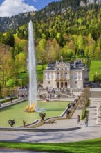 Water parterre with large fountain and portal of Linderhof Castle in spring, municipality of Ettal,