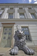 Head of lion figure and entrance to historic lion building, front door, palace, modern art,